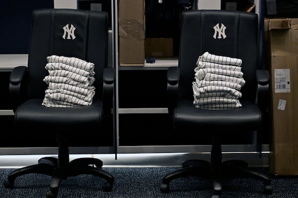 New York Yankees uniform pants are stacked on chairs near the players' lockers during a tour of the upgraded team spring training facilities Thursday, Feb. 13, 2025, at George M. Steinbrenner Field in Tampa, Fla. (AP Photo/Steve Nesius)