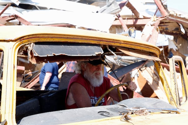 Tony Robertson drives a damaged pickup truck out of the way after a tornado passed through the area Sunday, March 16, 2025, in Plantersville, Ala. (AP Photo/Butch Dill)