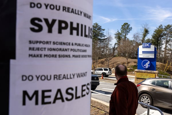 Demonstrators protest the mass firing of 1,000 Centers for Disease Control and Prevention (CDC) employees in front of the CDC headquarters in Atlanta on Tuesday, Feb. 18, 2025. (Arvin Temkar/Atlanta Journal-Constitution via AP)