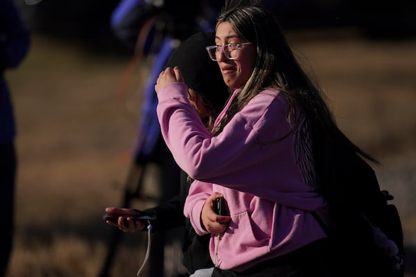 A student walks from the Antioch High School after a shooting in Nashville, Tenn., Wednesday, Jan. 22, 2025. (AP Photo/George Walker IV)