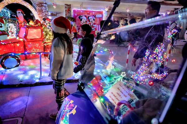 Local children walk the Wakefield Winter Wonderland neighborhood decorated with Christmas lights in Santa Clarita, Calif. on Dec. 17, 2024. (AP Photo/Richard Vogel)