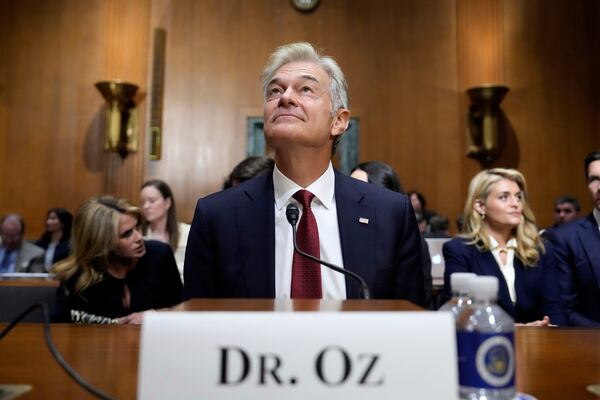 Dr. Mehmet Oz, President Donald Trump's pick to lead the Centers for Medicare and Medicaid Services, joined by wife Lisa Oz, left, and daughter Daphne Oz, right, sits before testifying at his confirmation hearing before the Senate Finance Committee, on Capitol Hill in Washington, Friday, March 14, 2025. (AP Photo/Ben Curtis)