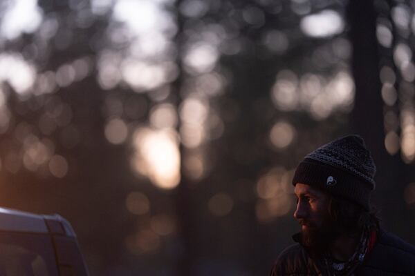Nick Campbell looks up while talking to a volunteer at a homeless encampment in Deschutes National Forest Wednesday, April 30, 2025 near Bend, Ore. (AP Photo/Jenny Kane)