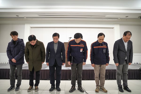 Jeju Air CEO Kim E-bae, fourth from left, and other executive members bow in apology ahead of a briefing in Seoul, South Korea, Sunday, Dec. 29, 2024 after its passenger plane burst into flames at an airport in the town of Muan. (Im Hun-jung/Yonhap via AP)