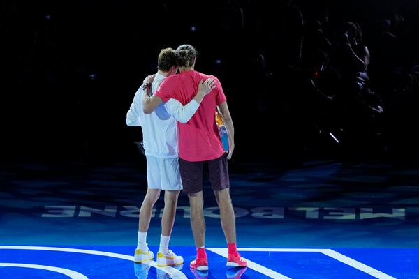 Jannik Sinner of Italy, left, is congratulated by Alexander Zverev of Germany following the men's singles final at the Australian Open tennis championship in Melbourne, Australia, Sunday, Jan. 26, 2025. (AP Photo/Vincent Thian)