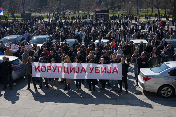 People hold a banner that reads: "Corruption kills" during a Serbia's parliament session in Belgrade, Serbia, Tuesday, March 4, 2025. (AP Photo/Darko Vojinovic)