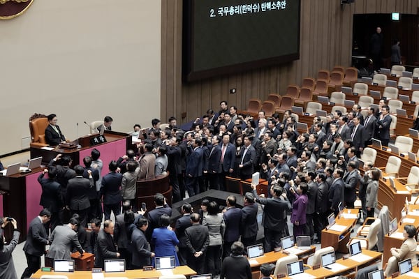 Lawmakers of the ruling People Power Party protest to South Korea's National Assembly Speaker Woo Won Shik, top left, during a plenary session for the impeachment motion against South Korean acting President Han Duck-soo at the National Assembly in Seoul, South Korea, Friday Dec. 27, 2024. (AP Photo/Ahn Young-joon)