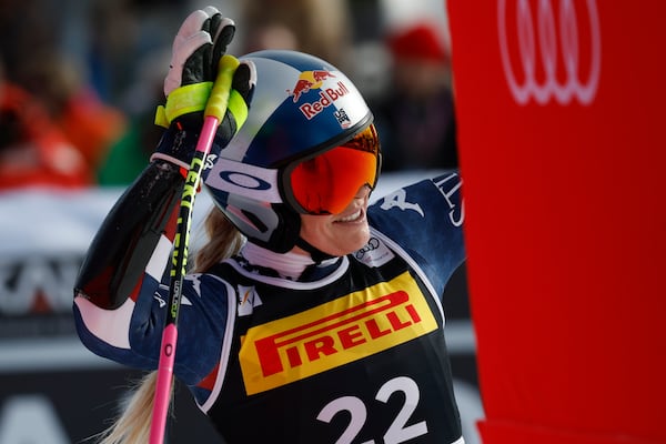 United States' Lindsey Vonn waves at the finish area after crashing during an alpine ski, women's World Cup Super-G, in Cortina d'Ampezzo, Italy, Sunday, Jan. 19, 2025 (AP Photo/Alessandro Trovati)