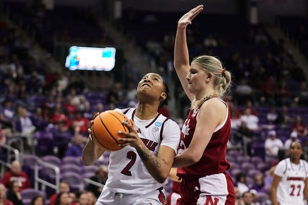 Louisville forward Nyla Harris (2) prepares to shoot as Nebraska's Petra Bozan, right, defends in the second half in the first round of the NCAA college basketball tournament in Fort Worth, Texas, Friday, March 21, 2025. (AP Photo/Tony Gutierrez)