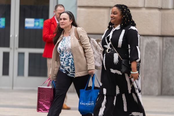 United States Agency for International Development (USAID) workers, carry their personal belongings after retrieving them from the USAID's headquarters in Washington, Thursday, Feb. 27, 2025. (AP Photo/Manuel Balce Ceneta)