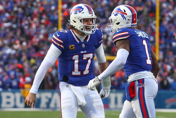 Buffalo Bills quarterback Josh Allen (17) celebrates with wide receiver Curtis Samuel (1) after Samuel scored a touchdown against the Denver Broncos during the fourth quarter of an NFL wild card playoff football game, Sunday, Jan. 12, 2025, in Orchard Park, N.Y. (AP Photo/Jeffrey T. Barnes)