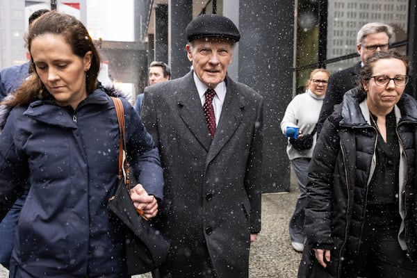 Flanked by supporters and holding hands with his daughter Nicole, Illinois' former House Speaker Michael Madigan walks out of the Dirksen Federal Courthouse in Chicago, Wednesday, Feb. 12, 2025. (Ashlee Rezin/Chicago Sun-Times via AP)