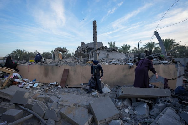 Palestinians inspect the site of an Israeli strike in Deir Al-Balah in the central Gaza Strip, Wednesday, Jan. 15, 2025. (AP Photo/Abdel Kareem Hana)