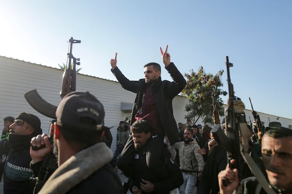 A freed Palestinian prisoner, center, is greeted by a crowd as he arrives in the Gaza Strip after being released from an Israeli prison following a ceasefire agreement between Hamas and Israel in Khan Younis, Saturday, Feb. 1, 2025. (AP Photo/Jehad Alshrafi)