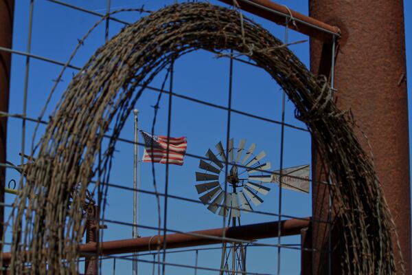 An American flag and windmill appear on display at rancher Brantley Baird's pioneer museum in Joseph City, Ariz., Wednesday, April 23, 2025. (AP Photo/Susan Montoya Bryan)