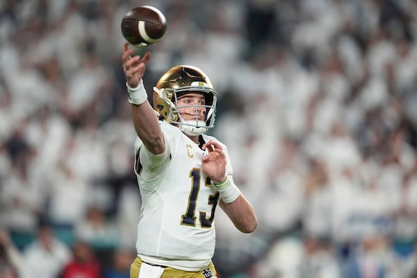 Notre Dame quarterback Riley Leonard (13) aims a pass during first half of the Orange Bowl NCAA College Football Playoff semifinal game against Penn State, Thursday, Jan. 9, 2025, in Miami Gardens, Fla. (AP Photo/Rebecca Blackwell)