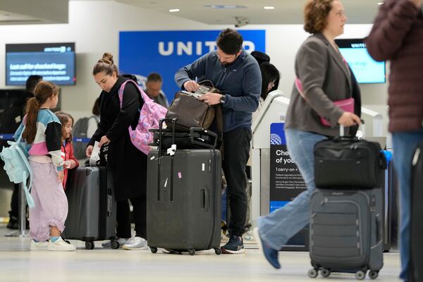 Travelers check into their flights at Newark Liberty International Airport in Newark, N.J., Monday, May 5, 2025. (AP Photo/Seth Wenig)