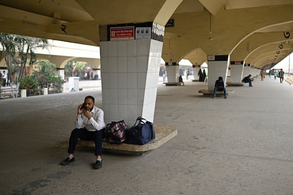 Stranded passengers wait at a railway station, after trains across the country have been canceled as railway workers went on strike for higher pensions and other benefits, in Dhaka, Bangladesh, Tuesday, Jan. 28, 2025. (AP Photo/Mahmud Hossain Opu)