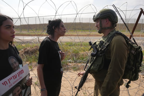 Einav Zangauker, mother Matan, who is held hostage by Hamas in the Gaza Strip, and other relatives of hostages attempt to approach the Gaza border, escorted by Israeli soldiers, calling for their release and expressing concerns that the resumption of fighting in Gaza puts their loved ones at risk, in southern Israel, Tuesday, March 18, 2025. (AP Photo/Ohad Zwigenberg)