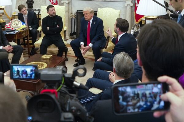 Vice President JD Vance, right, speaks with Ukrainian President Volodymyr Zelenskyy, left, as President Donald Trump, center, listens in the Oval Office at the White House, Friday, Feb. 28, 2025, in Washington. (AP Photo/ Mystyslav Chernov)