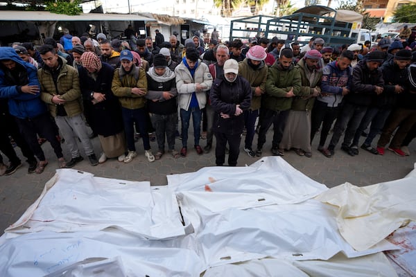 Palestinians attend funeral prayers over the bodies of those killed in overnight Israeli airstrikes on the Maghazi refugee camp, at Al-Aqsa Hospital, in Deir al-Balah, central Gaza Strip, Saturday, Dec. 28, 2024. (AP Photo/Abdel Kareem Hana)