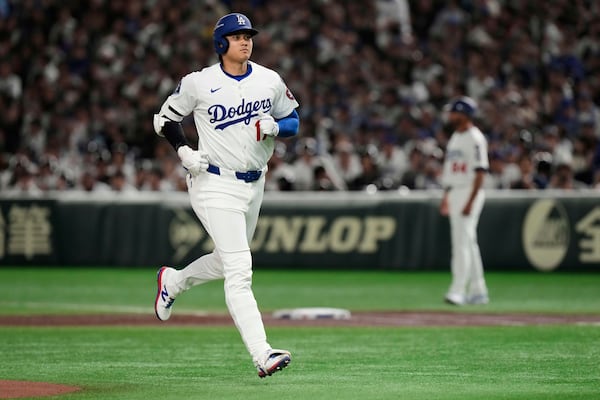 Los Angeles Dodgers' Shohei Ohtani jogs to the dugout after flying out to left in the first inning of an MLB Tokyo Series baseball game against the Chicago Cubs in Tokyo, Japan, Wednesday, March 19, 2025. (AP Photo/Eugene Hoshiko)