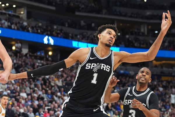 San Antonio Spurs center Victor Wembanyama pursues a rebound in the first half of an NBA basketball game against the Denver Nuggets Friday, Jan. 3, 2025, in Denver. (AP Photo/David Zalubowski)