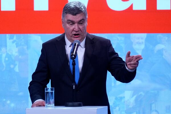 President incumbent Zoran Milanovic addresses his supporters as the preliminary results grant him victory in a runoff vote for the Croatian presidential election in Zagreb, Croatia, Sunday, Jan. 12, 2025. The sign reads "Thank You". (AP Photo/Darko Bandic)