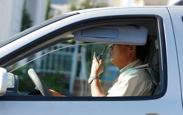 FILE - A man talks on his cell phone while driving in Los Angeles, Monday June 30, 2008. (AP Photo/Kevork Djansezian, File)