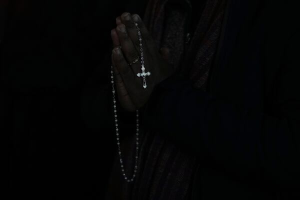 A man holds a rosary beads during a rosary prayer for Pope Francis' health in St. Peter's Square at the Vatican, Tuesday, March 4, 2025. (AP Photo/Alessandra Tarantino)