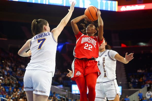 Ohio State guard Jaloni Cambridge (22) shoots against UCLA guard Elina Aarnisalo (7) as UCLA center Lauren Betts watches during the first half of an NCAA college basketball game Wednesday, Feb. 5, 2025, in Los Angeles. (AP Photo/Jessie Alcheh)