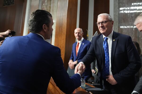 Pete Hegseth, left, President-elect Donald Trump's choice to be Defense secretary, shakes hands with Sen. Kevin Cramer, R-N.D., right, after appearing before the Senate Armed Services Committee for his confirmation hearing, at the Capitol in Washington, Tuesday, Jan. 14, 2025. (AP Photo/Jacquelyn Martin)