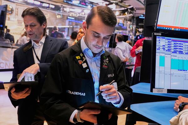Trader Dylan Halvorsan, right, works on the floor of the New York Stock Exchange, Thursday, May 1, 2025. (AP Photo/Richard Drew)