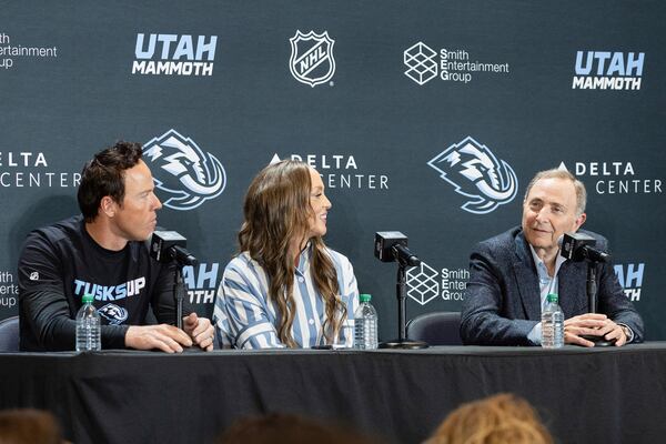 Chairman of Smith Entertainment Group Ryan Smith, Co-Founder Ashley Smith and NHL Commissioner Gary Bettman, from left, announce the Utah Mammoth as the new name and branding identity of Utah's NHL franchise, Wednesday, May 7, 2025, in Salt Lake City. (AP Photo/Melissa Majchrzak)