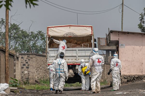 Red Cross personnel load bodies of victims of the fighting between Congolese government forces and M23 rebels in a truck in Goma, Democratic Republic of Congo, Monday, Feb. 3, 2025, as the U.N. health agency said 900 died in the fight. (AP Photo/Moses Sawasawa)