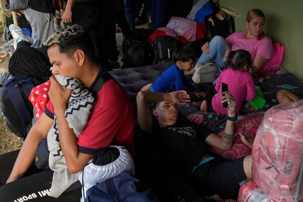 Venezuelan migrants prepare to spend the night in Puerto Carti, on Panama's Caribbean coast, Saturday, Feb. 22, 2025, where they plan to board boats to Colombia after turning back from southern Mexico where they gave up hopes of reaching the U.S. amid President Trump's crackdown on migration. (AP Photo/Matias Delacroix)