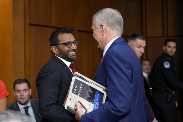 Kash Patel, President Donald Trump's choice to be director of the FBI, left, shakes the hand of Sen. Thom Tillis, R-N.C., as he departs following a confirmation hearing before the Senate Judiciary Committee at the Capitol in Washington, Thursday, Jan. 30, 2025. (AP Photo/Ben Curtis)