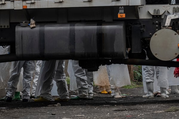 Red Cross personnel load bodies of victims of the fighting between Congolese government forces and M23 rebels in a truck in Goma, Monday, Feb. 3, 2025, as the U.N. health agency said 900 died in the fight. (AP Photo/Moses Sawasawa)