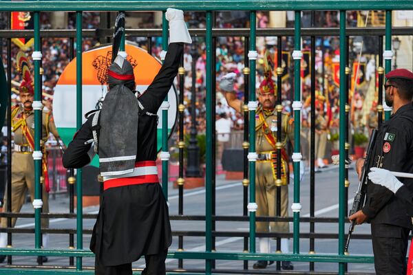 Pakistan's Rangers soldier, in black, and Indian Border Security Forces soldier, gesture to each other during a daily closing ceremony at the Wagah, a joint post on the Pakistan and India border, near Lahore, Pakistan, Saturday, May 3, 2025. (AP Photo/K.M. Chaudary)
