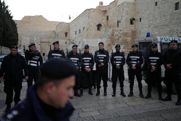 Palestinian police line up next to Church of the Nativity, traditionally believed to be the birthplace of Jesus, on Christmas Eve, in the West Bank city of Bethlehem, Tuesday, Dec. 24, 2024. (AP Photo/Matias Delacroix)