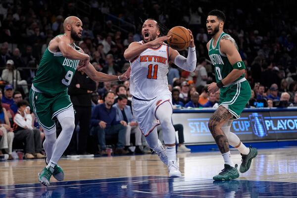 New York Knicks' Jalen Brunson, center, drives to the basket between Boston Celtics' Derrick White, left, and Jayson Tatum, right, during the first half of Game 3 of an NBA basketball second-round playoff series, Saturday, May 10, 2025, in New York. (AP Photo/Pamela Smith)