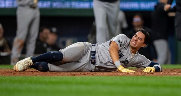 New York Yankees' Oswaldo Cabrera reacts after injuring his leg while scoring a run during the ninth inning of a baseball game against the Seattle Mariners, Monday, May 12, 2025, in Seattle. (AP Photo/Stephen Brashear)