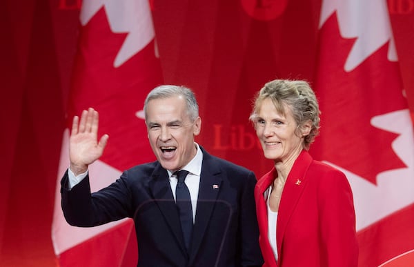 Newly appointed Liberal Leader Mark Carney and his wife Diana Fox Carney leave the stage following his speech at the Liberal leadership announcement in Ottawa, Ontario, Sunday, March 9, 2025. (Adrian Wyld/The Canadian Press via AP)