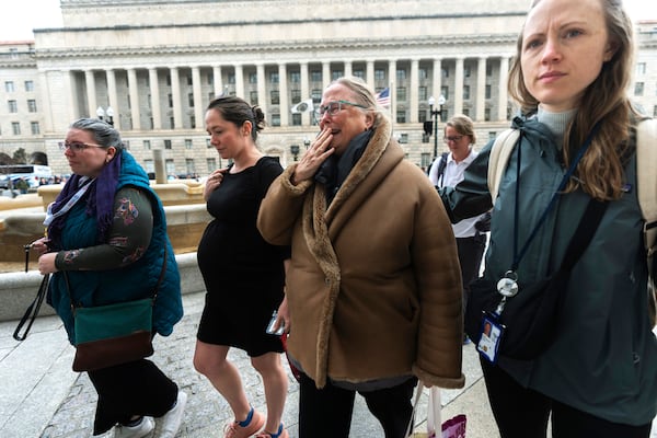 Lucy Mize, second from right, a United States Agency for International Development (USAID) health officer for 31 years, cries as she walks with fellow USAID workers to the USAID headquarters in Washington, to gather personal belongings, Thursday, Feb. 27, 2025, in Washington. (AP Photo/Manuel Balce Ceneta)