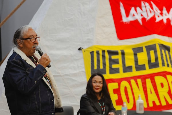 In this image provided by the NDN Collective, Leonard Peltier, left, a Native American activist released from a Florida prison where he had been serving a life sentence in the 1975 killings of two FBI agents, speaks to the crowd during a welcome event, Wednesday, Feb. 19, 2025, at the Sky Dancer Casino Resort near Belcourt, N.D., on the Turtle Mountain Reservation. (Angel White Eyes/NDN Collective via AP)