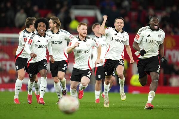 Fulham players celebrate after defeating Manchester United in a penalty shootout during the English FA Cup soccer match at the Old Trafford stadium in Manchester, England, Sunday, March 2, 2025. (AP Photo/Jon Super)