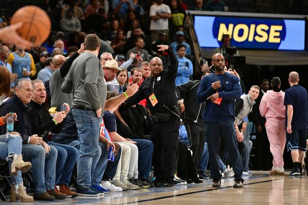 A police officer motions for help as a man has a medical emergency before an NBA basketball game between the San Antonio Spurs and the Memphis Grizzlies Monday, Feb. 3, 2025, in Memphis, Tenn. (AP Photo/Brandon Dill)