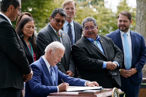 FILE - President Joe Biden signs proclamations on the North Lawn at the White House in Washington, Friday, Oct. 8, 2021. (AP Photo/Susan Walsh, File)