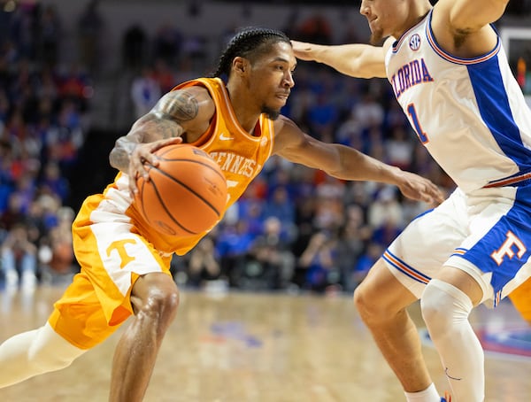 Tennessee guard Zakai Zeigler drives on Florida guard Walter Clayton Jr. (1) during the first half of an NCAA college basketball game, Tuesday, Jan. 7, 2025, in Gainesville, Fla. (AP Photo/Alan Youngblood)