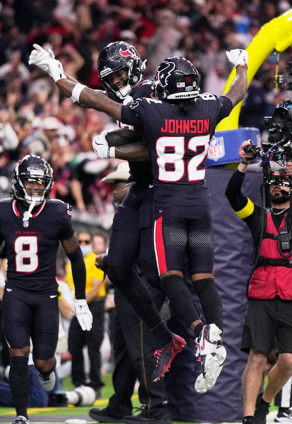 Houston Texans wide receiver Nico Collins, rear, celebrates with Diontae Johnson (82) after scoring a touchdown against the Los Angeles Chargers during the first half of an NFL wild-card playoff football game Saturday, Jan. 11, 2025, in Houston. (AP Photo/Eric Christian Smith)